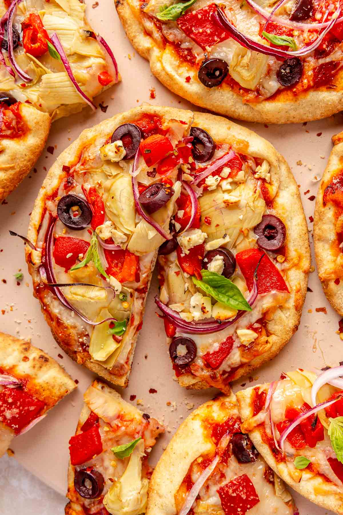 Greek pita pizza topped with basil and parmesan cheese.