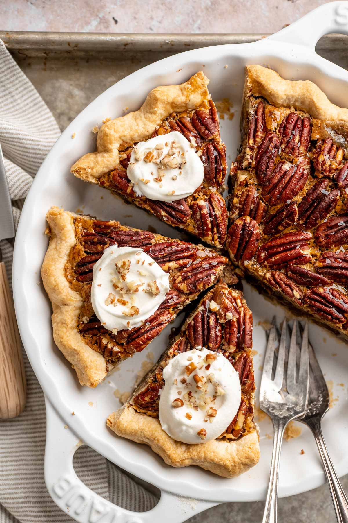 Pecan pie without corn syrup topped with whipped cream.