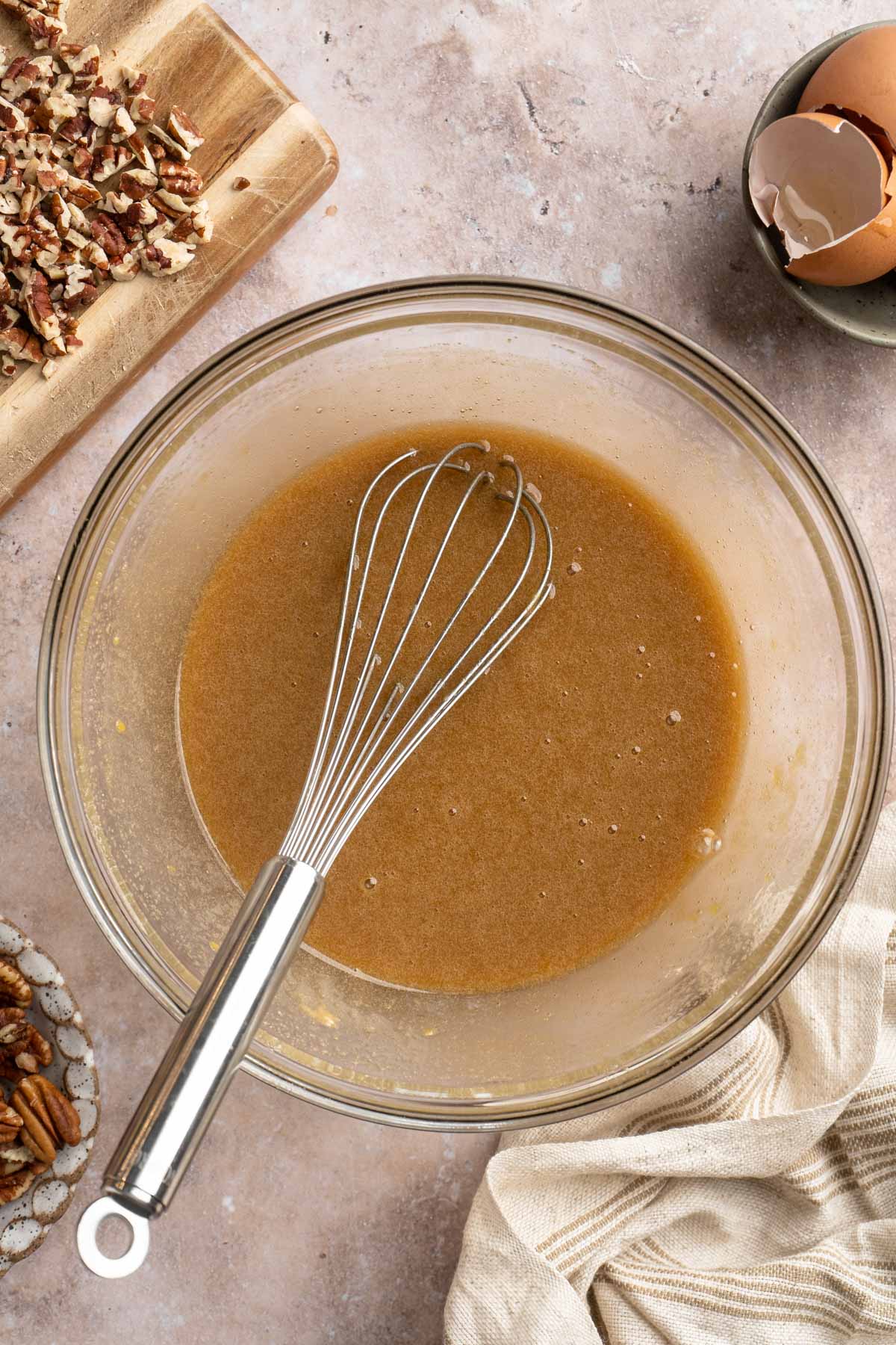 Whisking eggs, brown sugar, vanilla and flour in a large bowl.