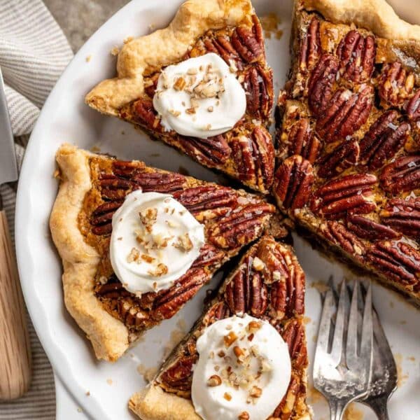 Pecan pie without corn syrup topped with whipped cream.