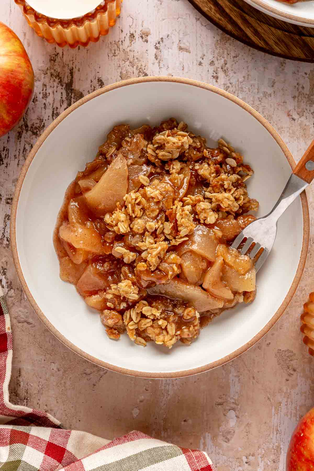 Apple crisp served in a bowl with a fork.