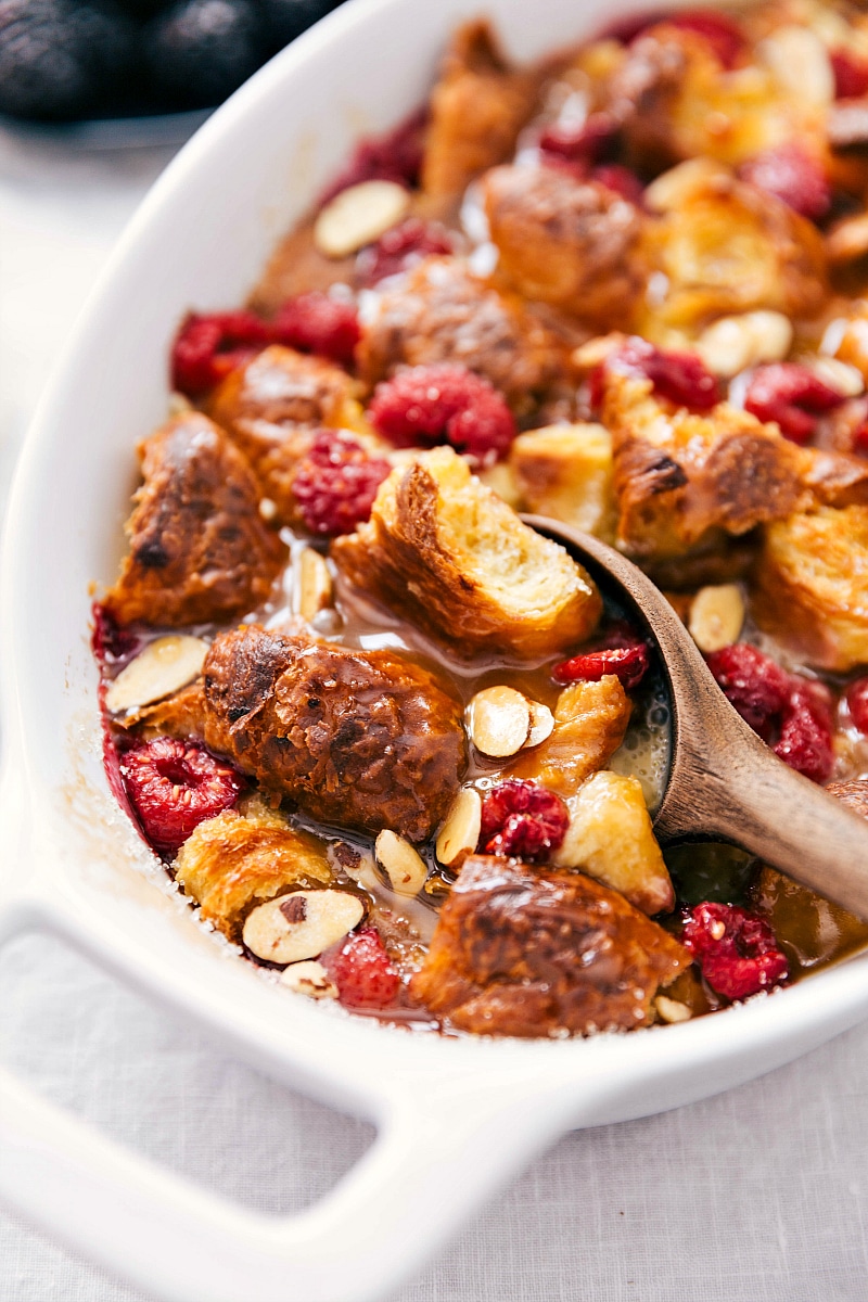 bread pudding topped with raspberries and sliced almonds