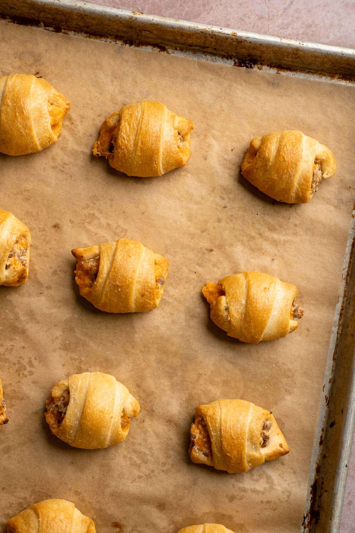 Baked breakfast crescent rolls on a sheet pan.