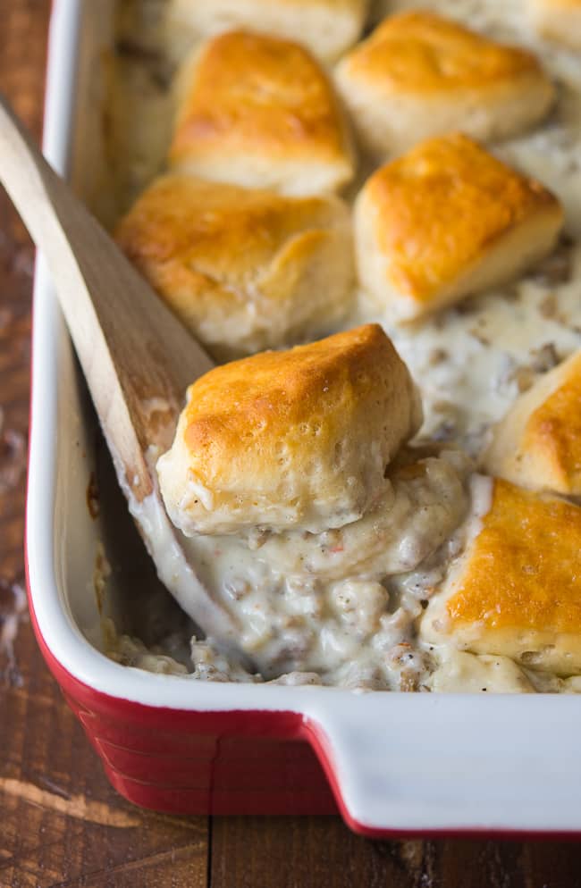 sausage gravy mix with biscuits on top being spooned out 