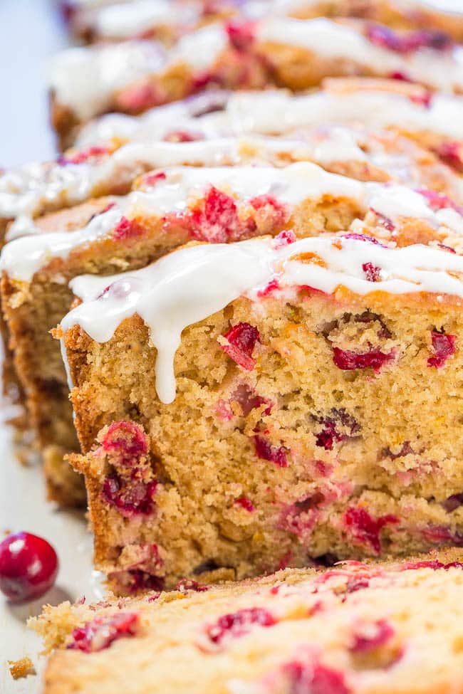 sliced cranberry orange bread with sweet orange glaze over the top