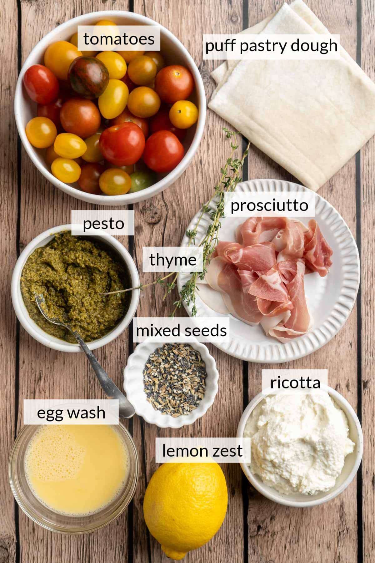 Small bowls with tomatoes, pesto, prosciutto and ricotta.