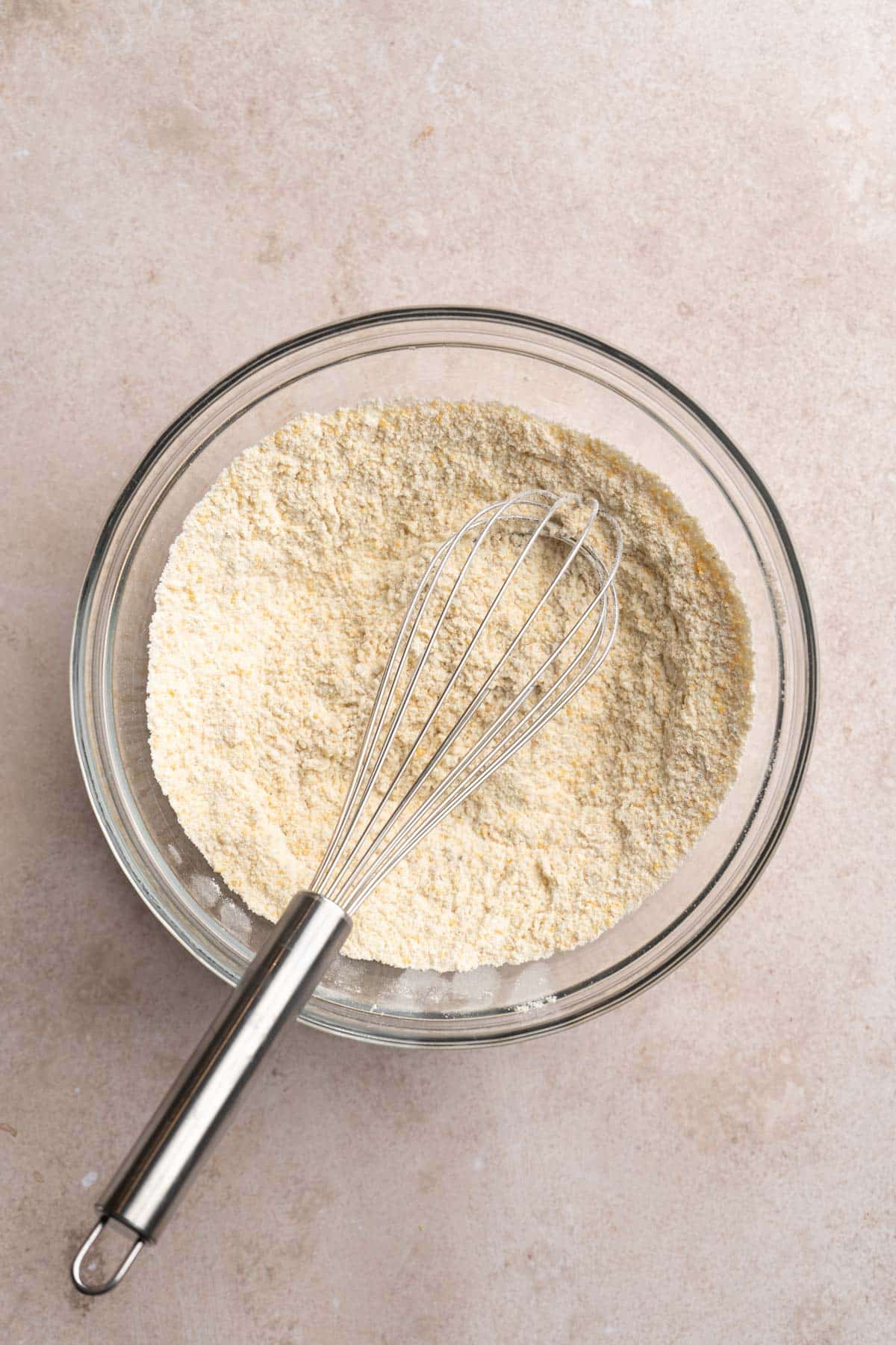 Whisking dry ingredients in a large bowl.