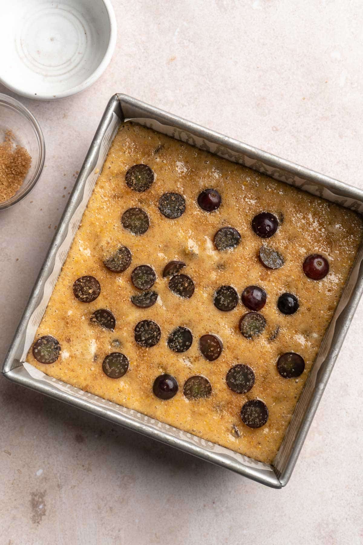 Sugar sprinkled over the top of a grape cake.