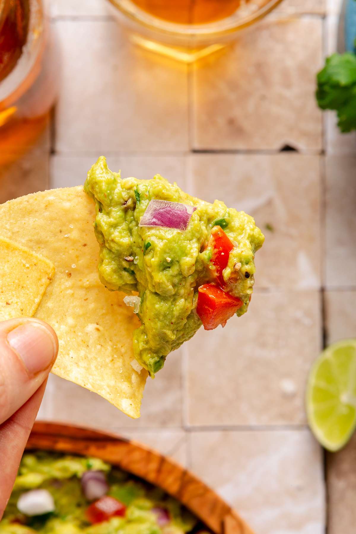 Tortilla chip dipped in guacamole.