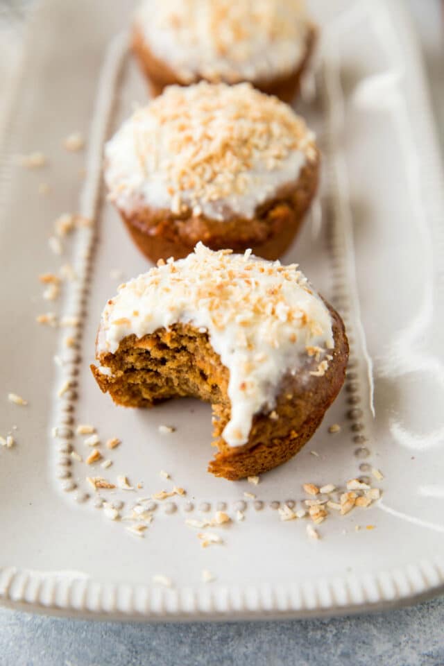 carrot muffins with cream cheese frosting and a toasted coconut topping