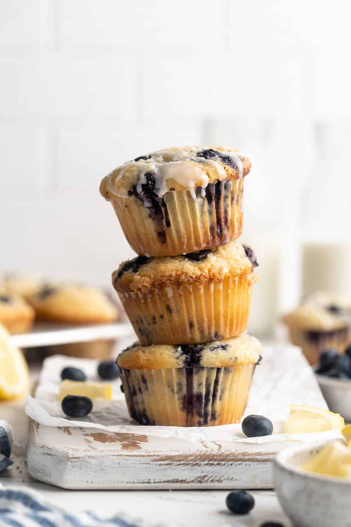 Three blueberry muffins stacked.