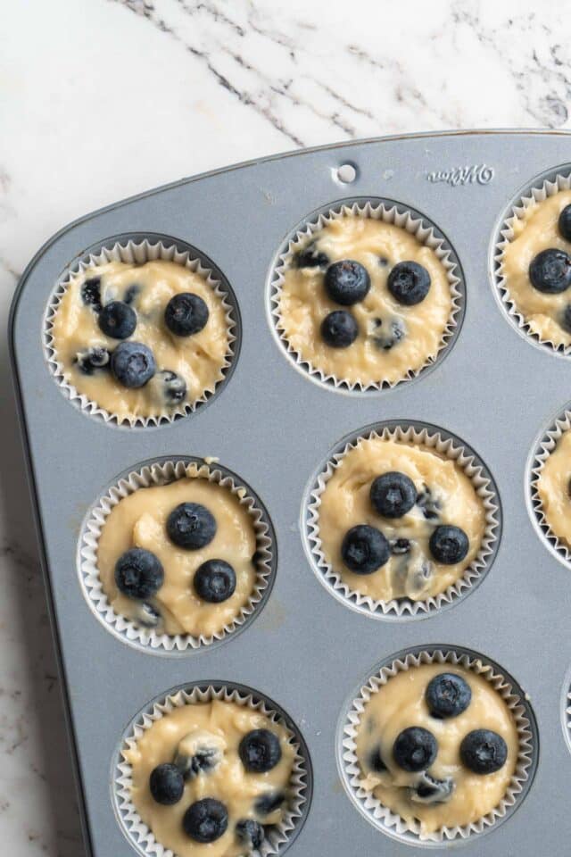 Blueberry muffin batter in pan.