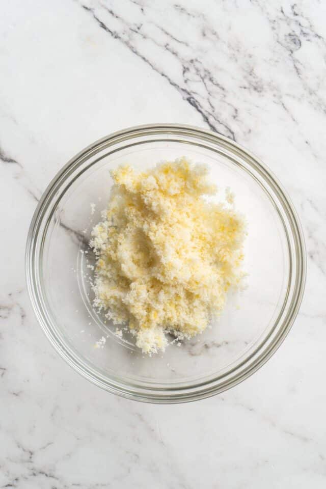 Mixture of lemon zest and sugar in a small bowl.