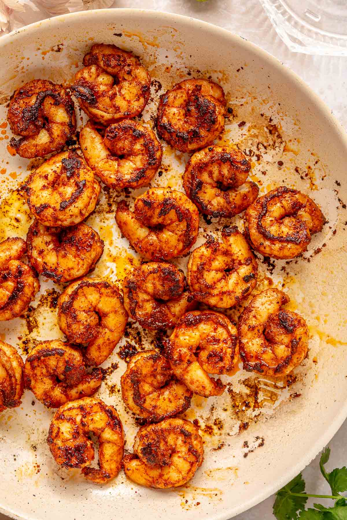 Sautéing shrimp in a large skillet.