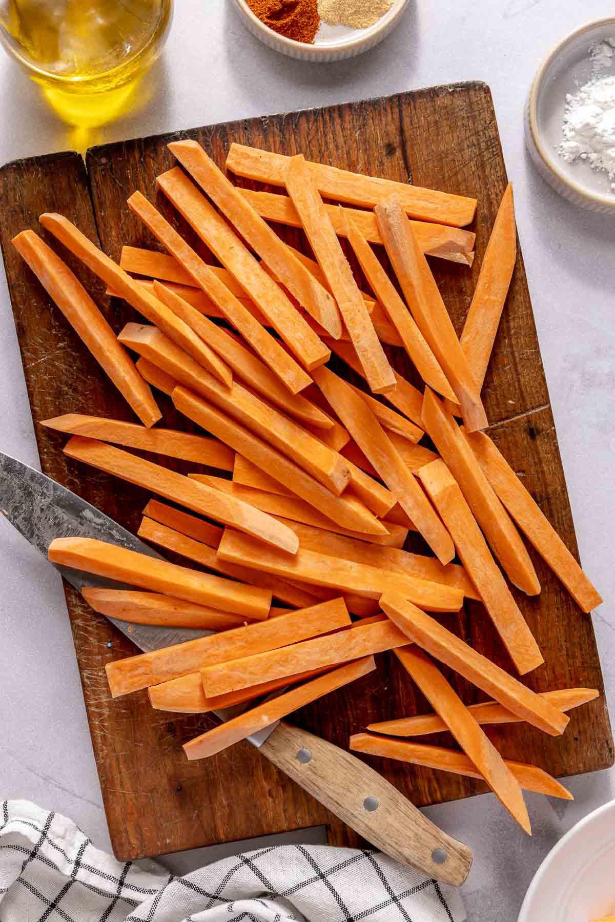 Sliced sweet potato on a cutting board.