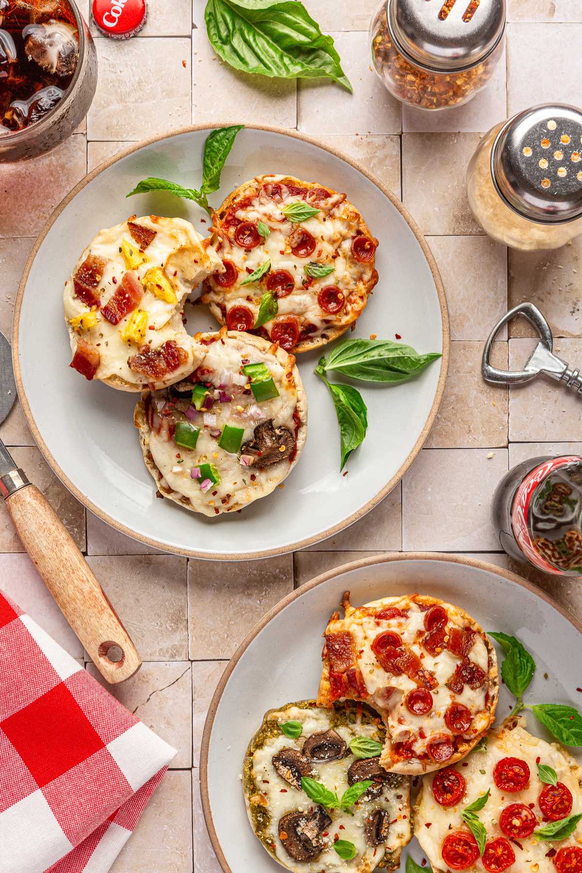 Mini pizzas on white plates.