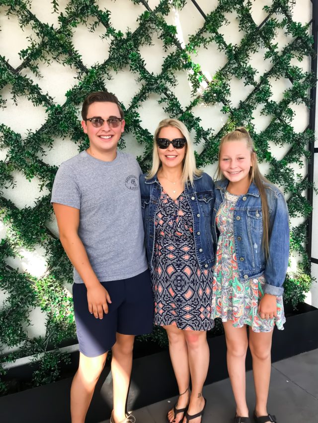 picture of three people in front of greenery at magnolia table