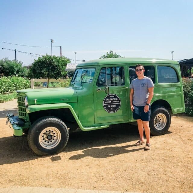 picture of boy in front of green truck at magnolia market