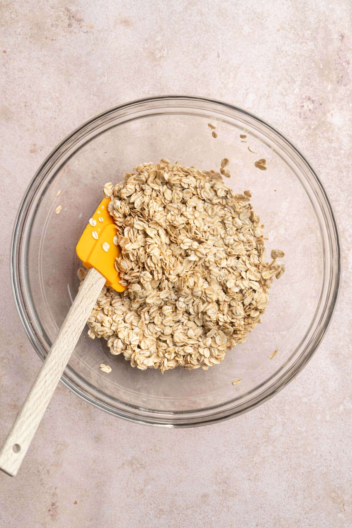 Stirring milk and oats together in a medium bowl.