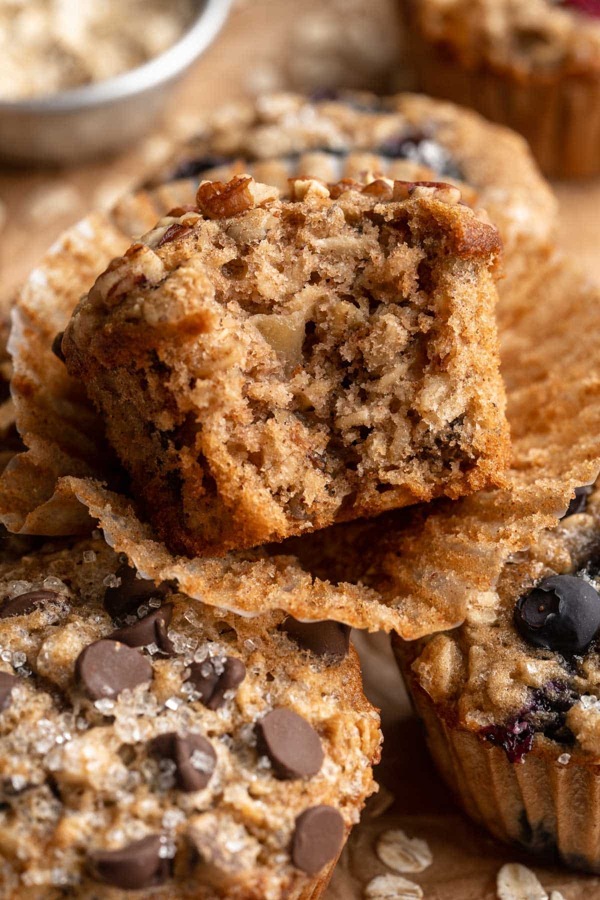 An oatmeal muffin that has a bite in it.