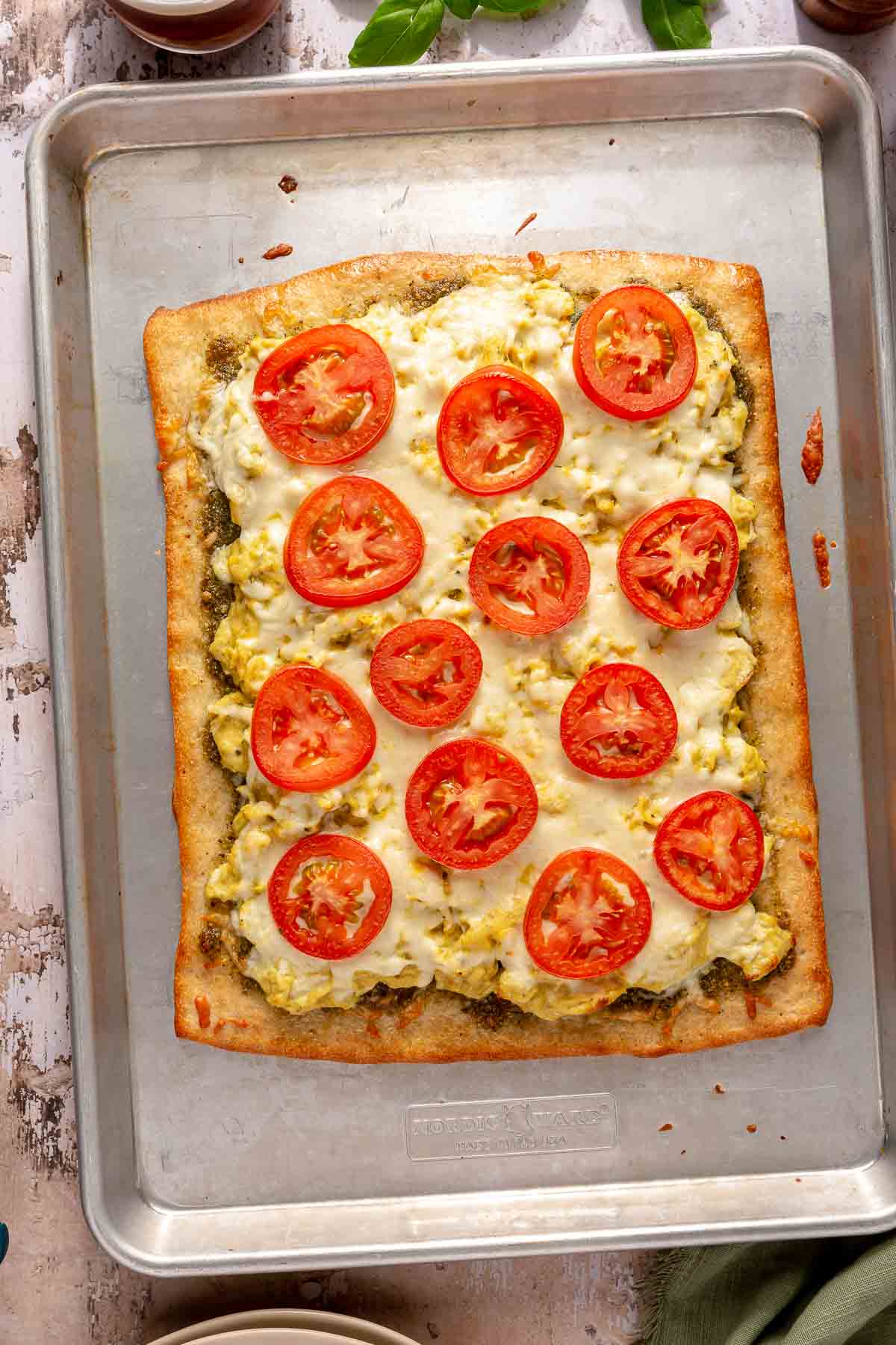 Baked breakfast pizza on a cookie sheet.