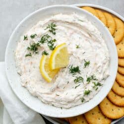 Smoked salmon topped with lemon wedges and fresh dill.