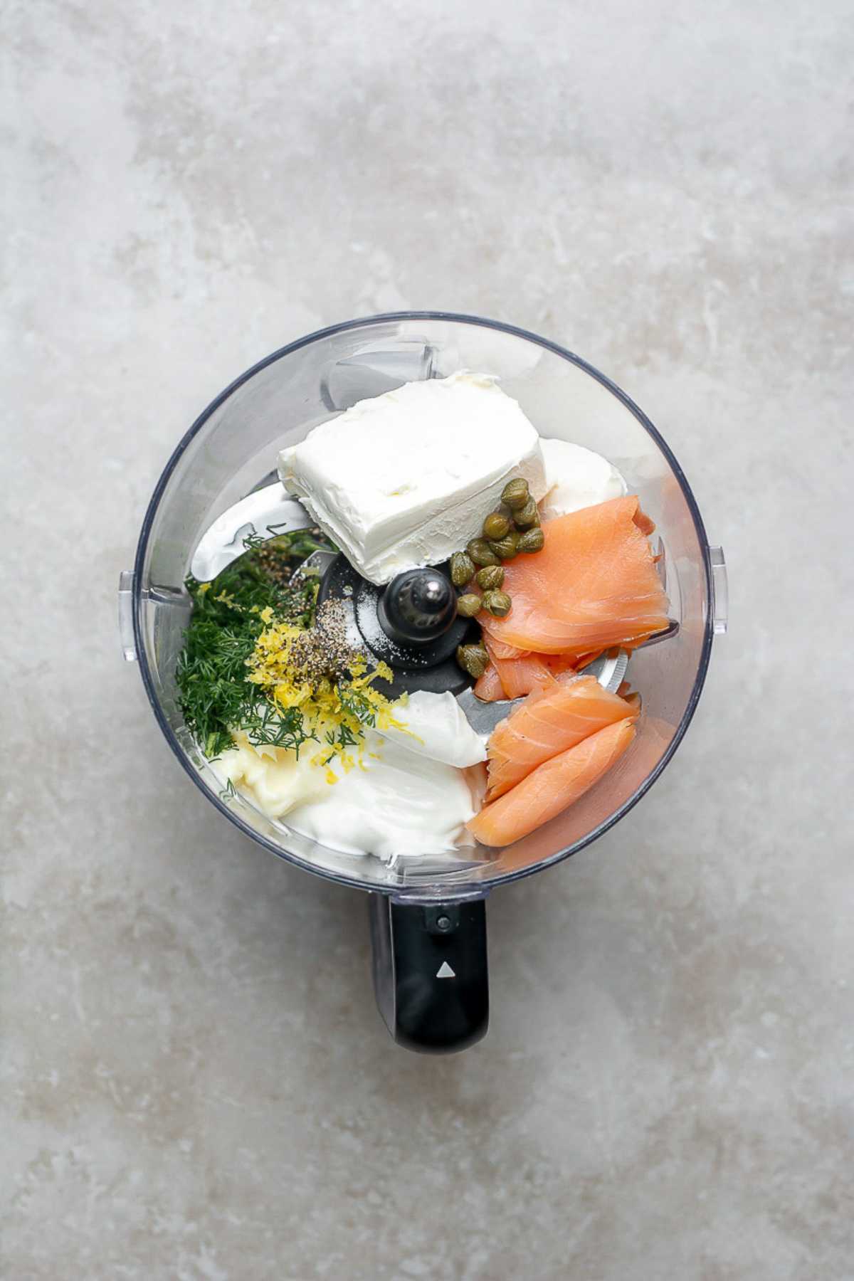 Smoked salmon, cream cheese, sour cream, mayo, dill, lemon zest and lemon juice in a food processor.