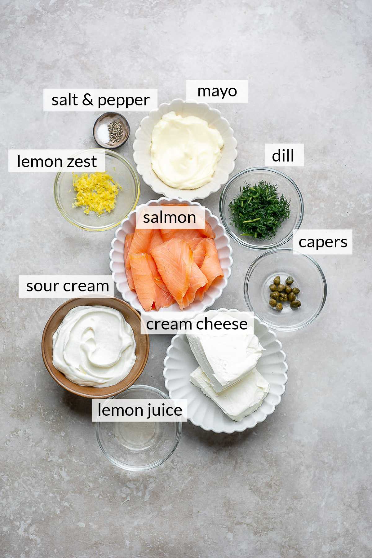 Smoked salmon, cream cheese, sour cream, mayo, dill, lemon zest and lemon juice divided into small bowls.