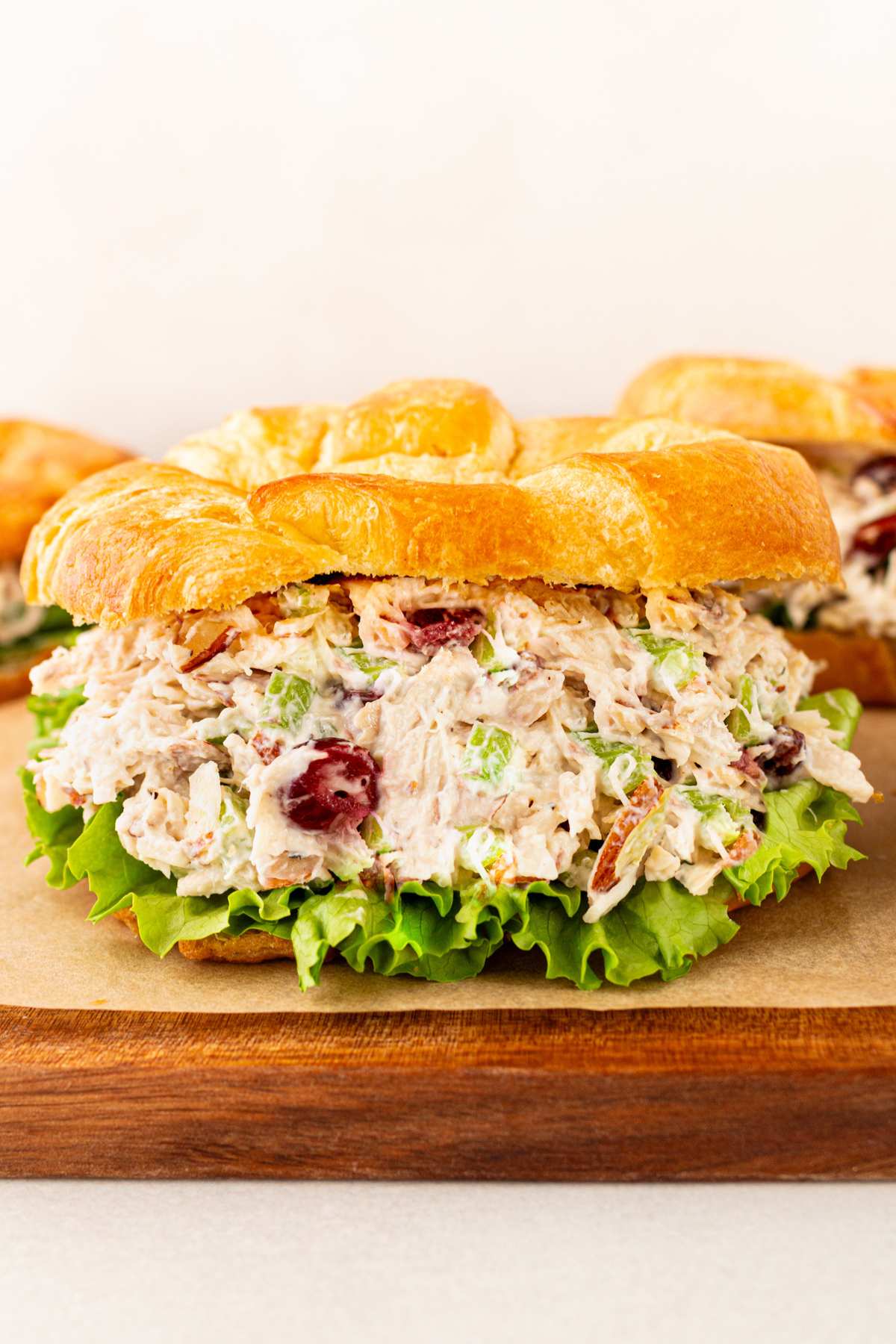 Chicken salad served on a croissant with lettuce.