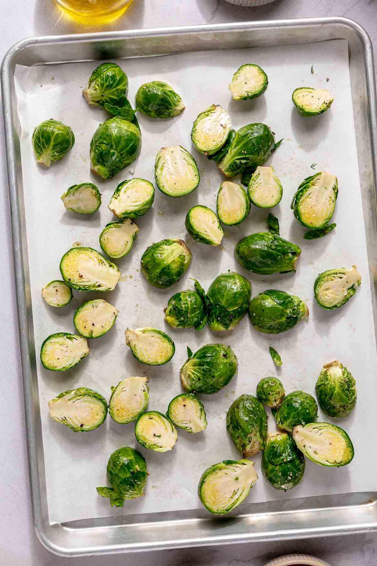 Brussels sprouts on a pan lined with parchment paper.