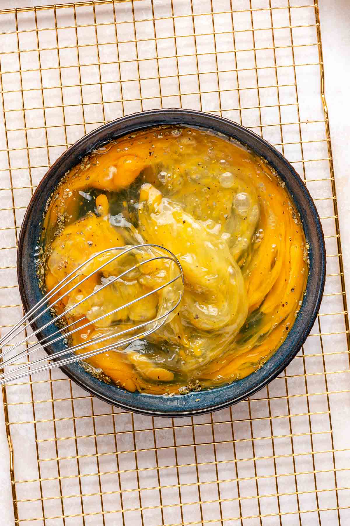 Whisking eggs in a large bowl.