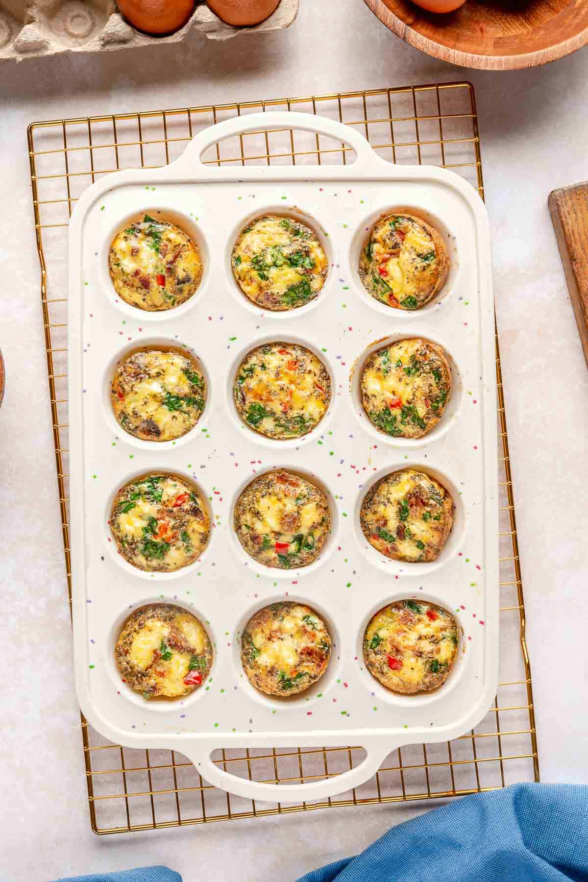 Baked egg muffin cups in a muffin pan.