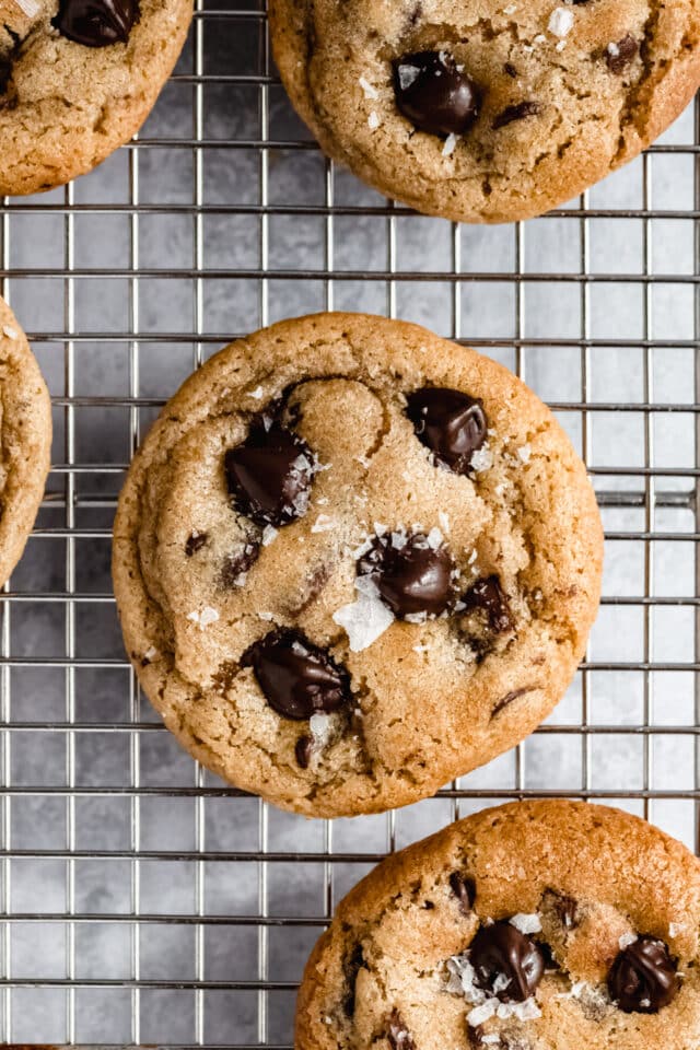 Sea salted chocolate chip cookie on a wire cooling rack.