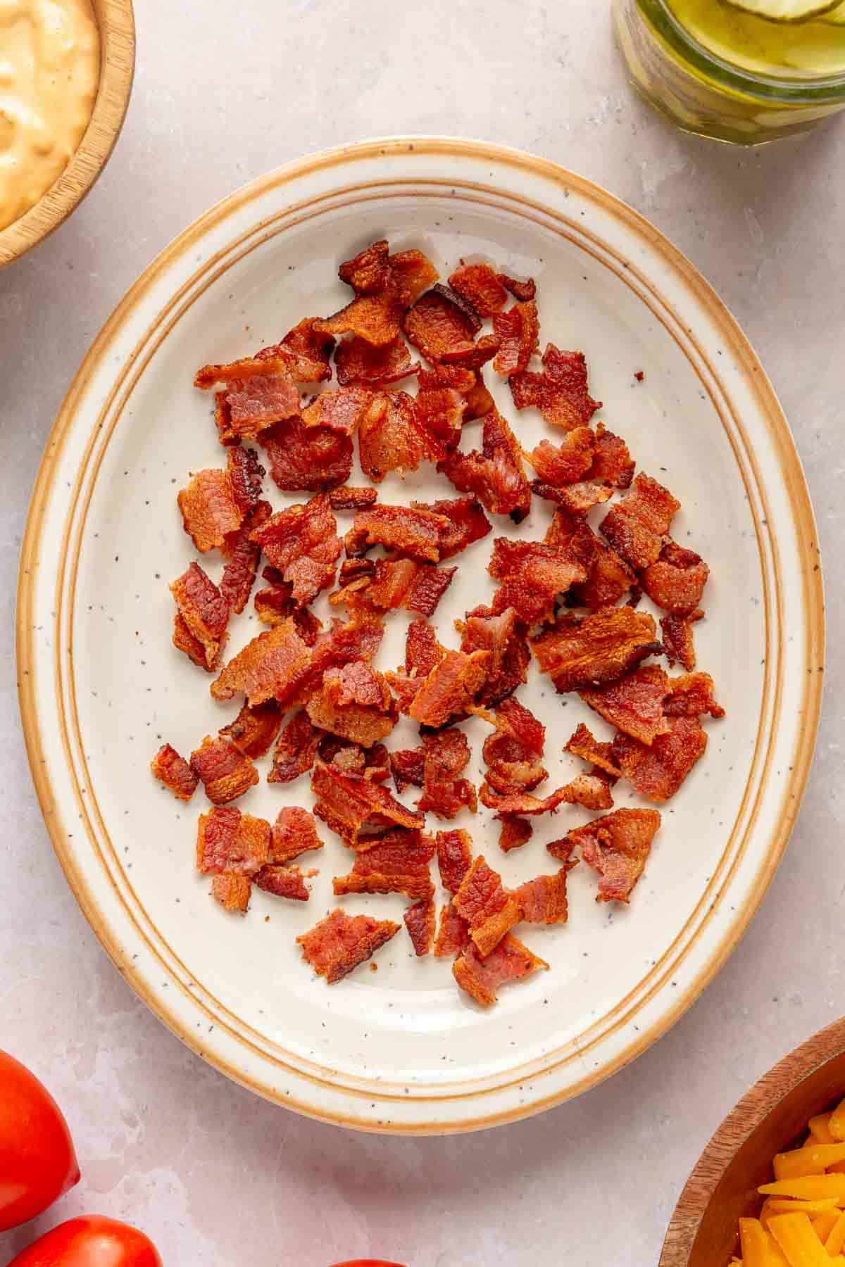 Crispy, crumbled bacon on a white plate.