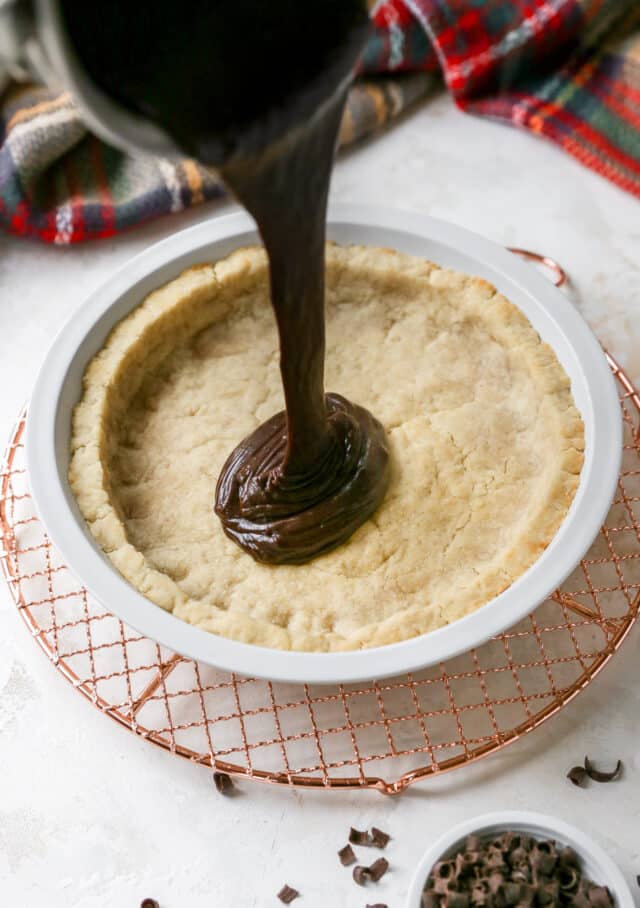 pouring chocolate filling into a pie crust