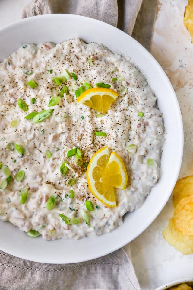 clam dip garnished with lemon slices and green onion