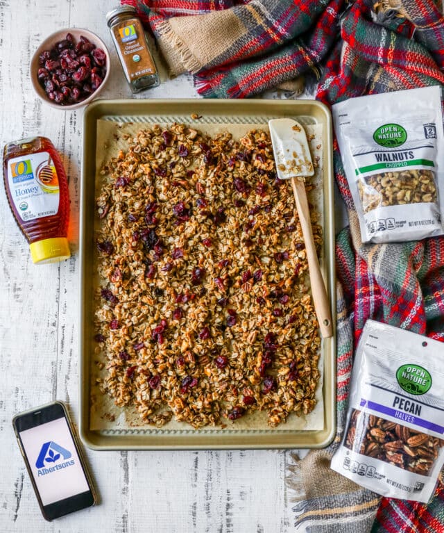 granola on a baking sheet near ingredients 