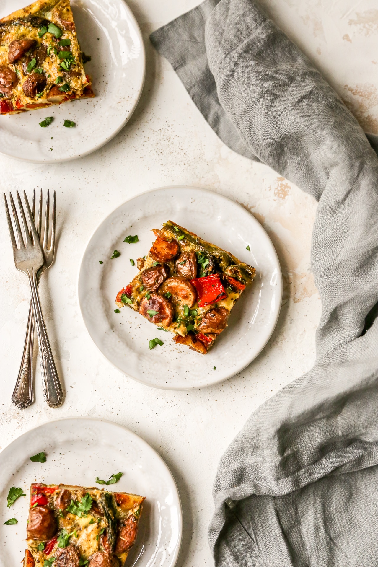 Healthy breakfast casserole served on white plates.