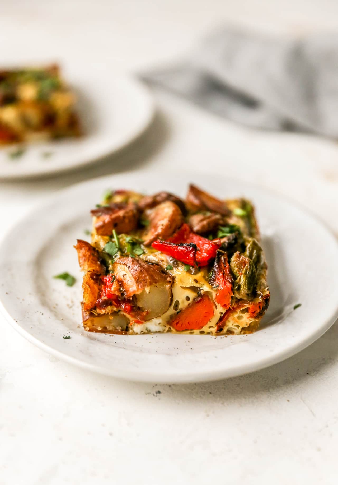 Vegetarian breakfast casserole served on a small white plate.