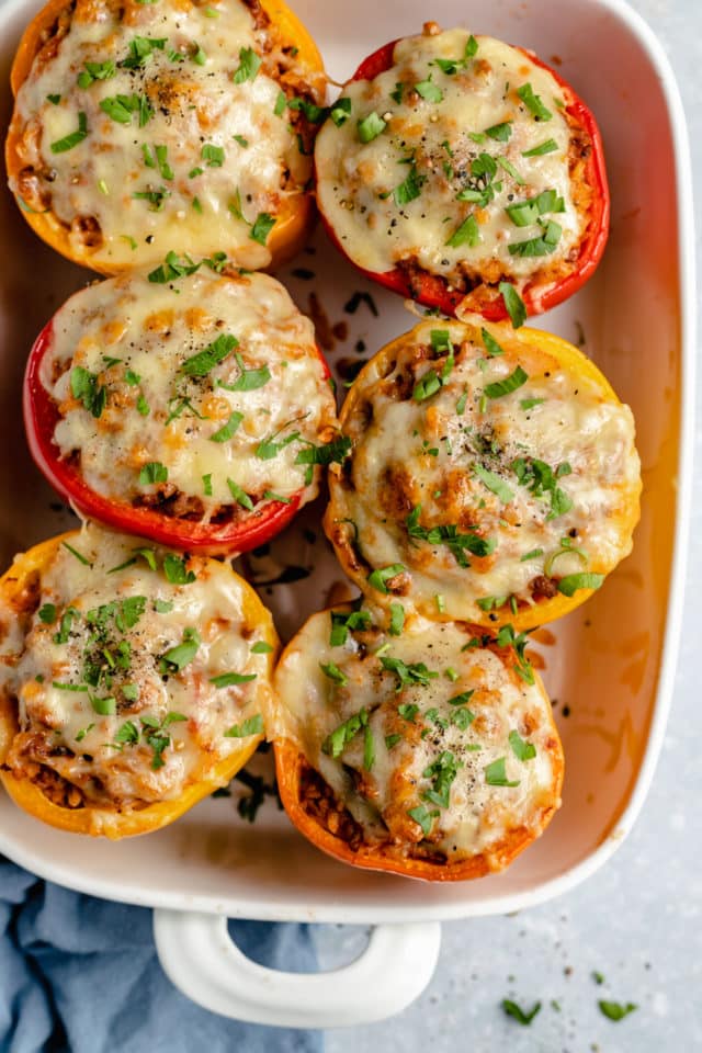 stuffed bell peppers topped with melty cheese and parsley