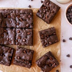 Cake mix brownies cut into bars on parchment paper.