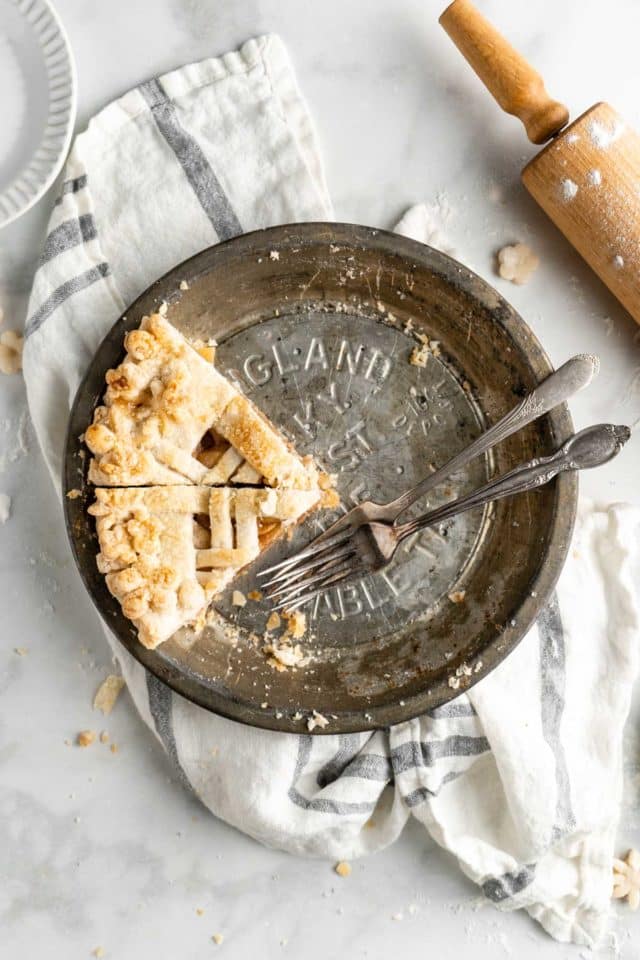 2 slices of apple pie left in a pie dish