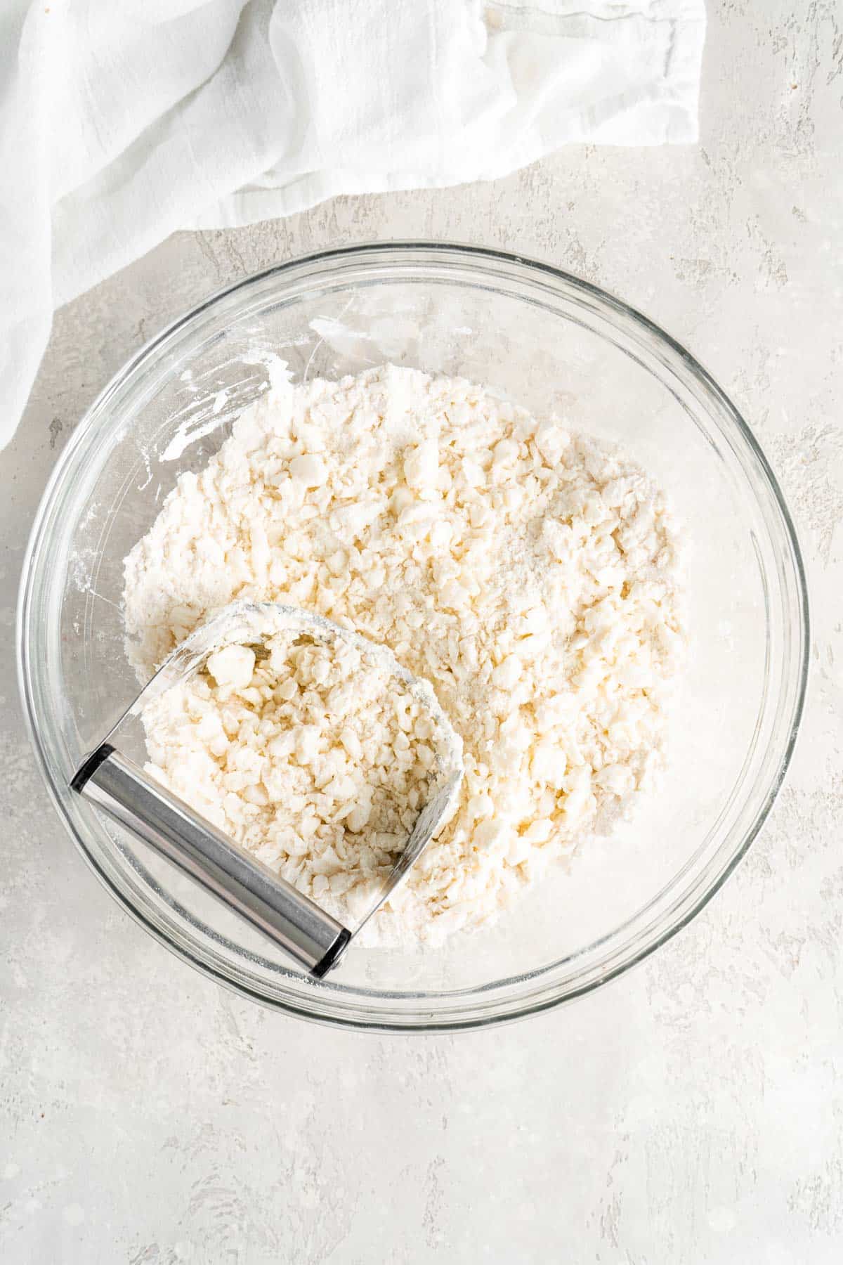 using a pastry cutter to cut fat flour mixture