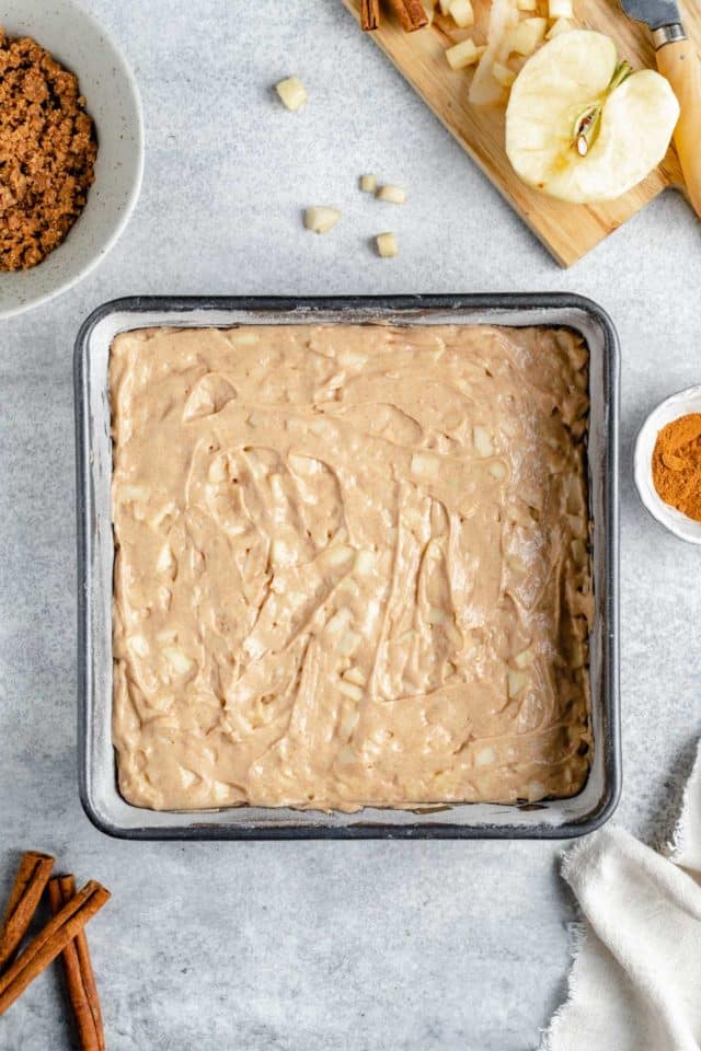 Pour apple cake batter into baking pan.