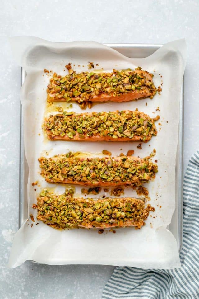 salmon fillets on a baking sheet lined with parchment paper