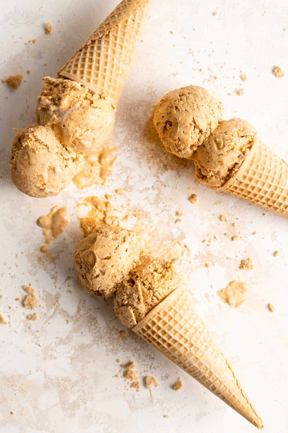 double scoops of pumpkin ice cream in sugar cones