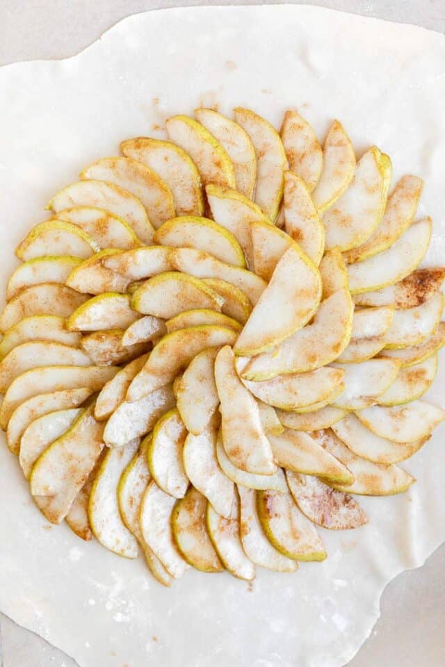 Pear slices patterned over pie dough.