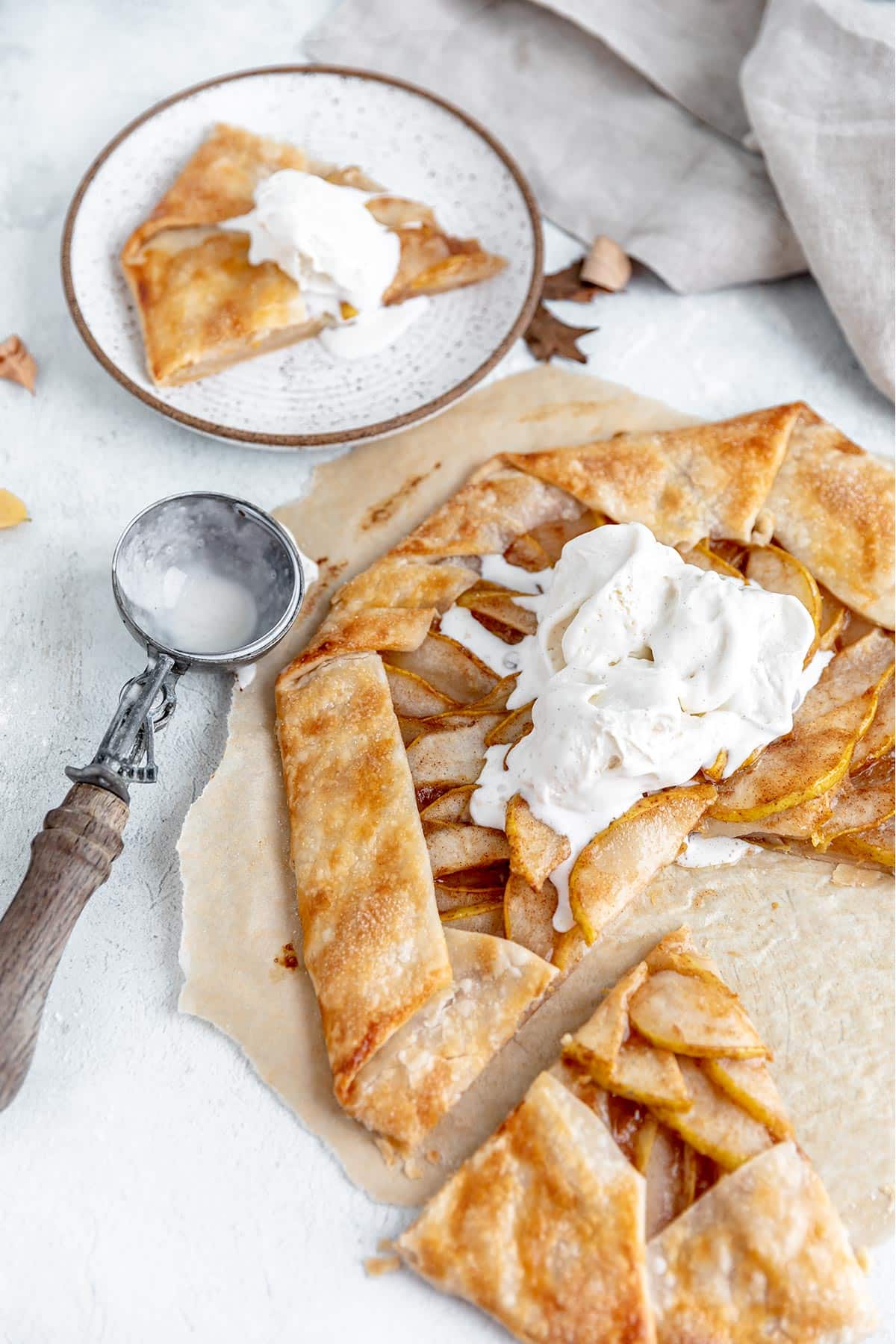 vanilla ice cream melting over a pear galette