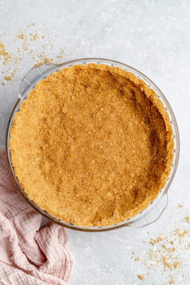 Graham cracker crust in a pie dish.