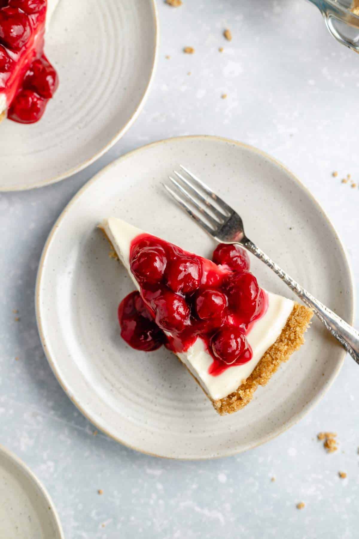 Cream cheese pie on a white plate with a fork.